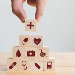 Picture of wooden blocks with various pictures representing the health care field