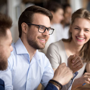 man smiling with colleagues