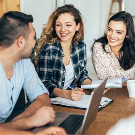 group of young people in workplace meeting