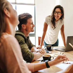 Picture of office colleagues chatting in their workspace