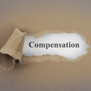 Paper partially torn back to reveal a the word Compensation