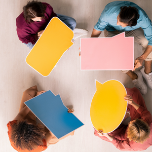 Picture of 4 people sitting in circle holding conversation bubbles