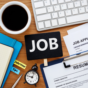 Picture of desktop showing resume, coffee mug, computer keyboard