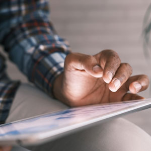 Picture of man's hand using ipad screen