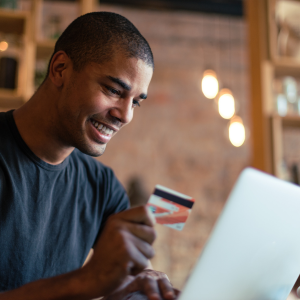 Picture of man using debit card to pay