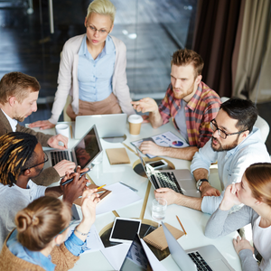 Picture of employees working around conference table