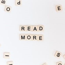 Small, off-white scrabble-like tiles with black letters; formed in the centre to say 