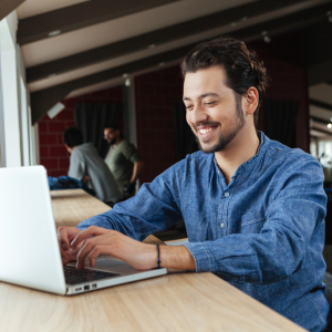Picture of man smiling looking at his keyboard