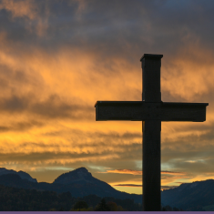 Picture of cross with sunset in background