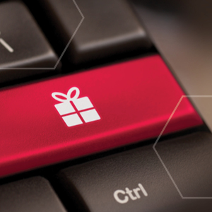 Picture of black keyboard with one red key with a white gift image the red key