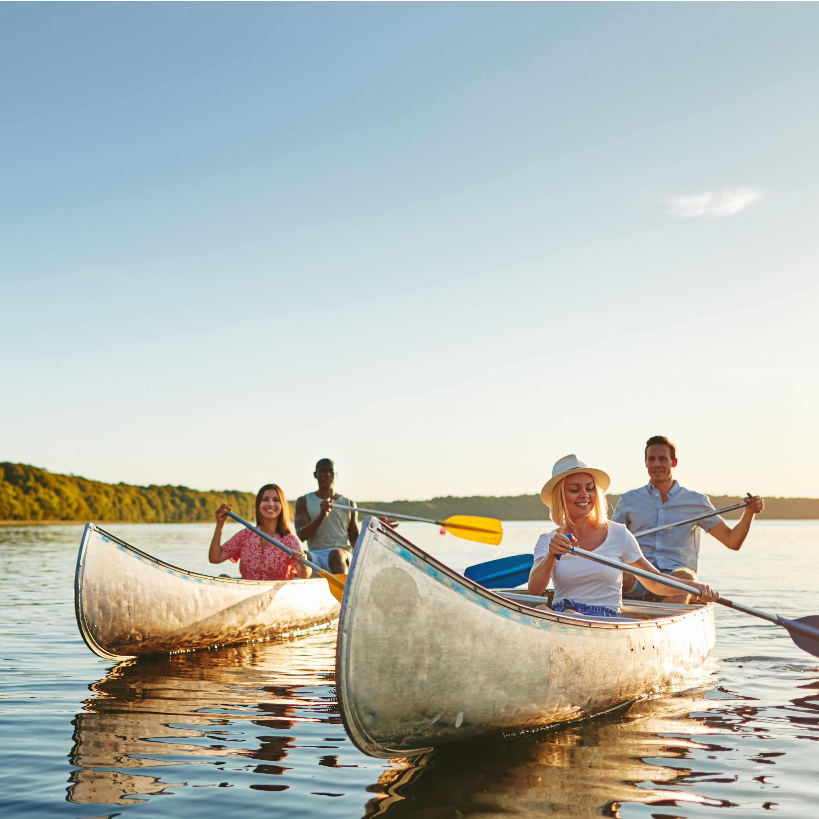 Picture of two couples in two canoes on lake