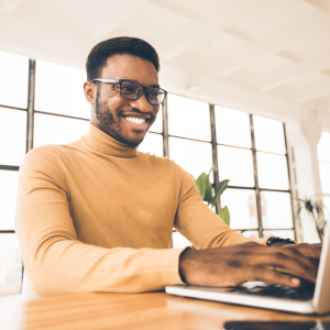 Smiling man working on laptop