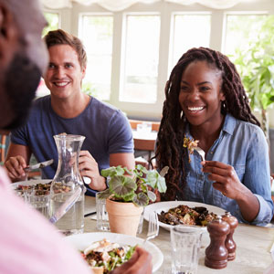 friends_at_table_in_restaurant_enjoying_meal_together