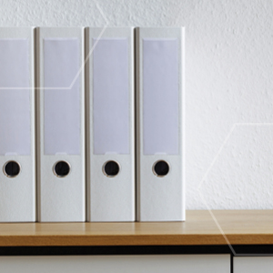 Picture of four binders standing on a cupboard