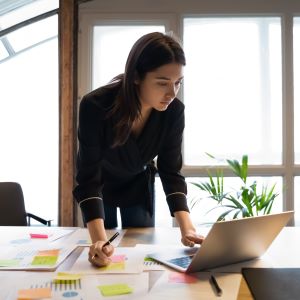 Picture of woman standing while working at her computer