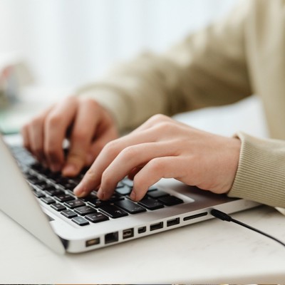 Person's hands working on laptop