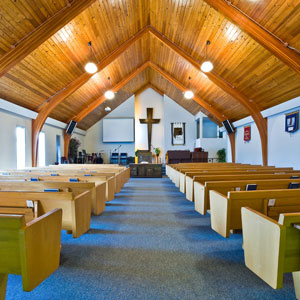 Picture of inside of church - pews and cross at front of church