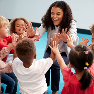 Picture of a woman playing with children  