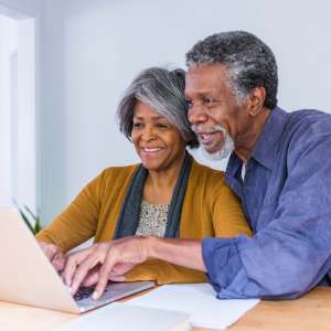 Smiling couple looking at laptop