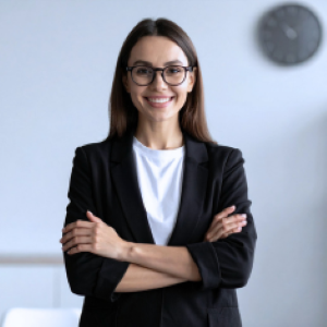 Smiling professional woman standing with arms crossed looking at camera