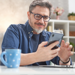 Picture of smiling man looking at cell phone