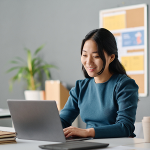Picture of women smiling and looking at laptop