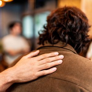 Picture of a caring hand on a man's back