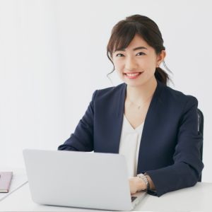 Smiling woman working at laptop