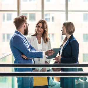 Three business colleagues in discussion. One male and two females.