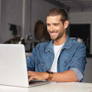 Smiling man working at laptop