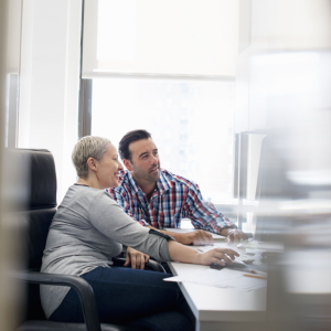 Picture of two people working at computer