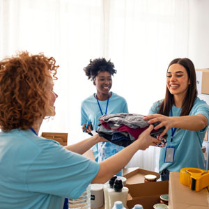 Woman helping others by giving clothing