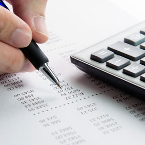 pen, calculator and finance sheet