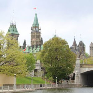 picture of canadian flag flying over parliament buildings