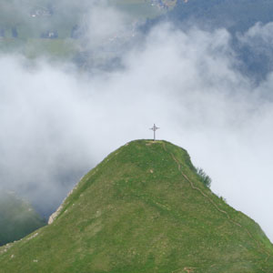 Picture of cross on the peak of a high hill