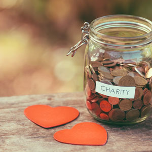 Picture of jar labelled charity filled with spare change