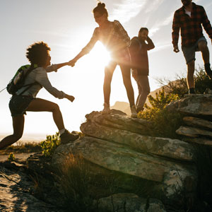 People climbing and helping each other