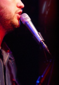 Man at microphone A man singing into a microphone with just his lips and chin visible