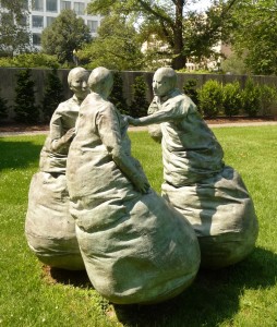 Sculpture of a person being shoved.