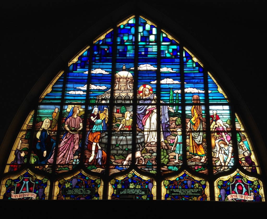 Stained Glass window of Jesus with people