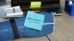 iStock photo of an arm cast with a post it note that says absent.