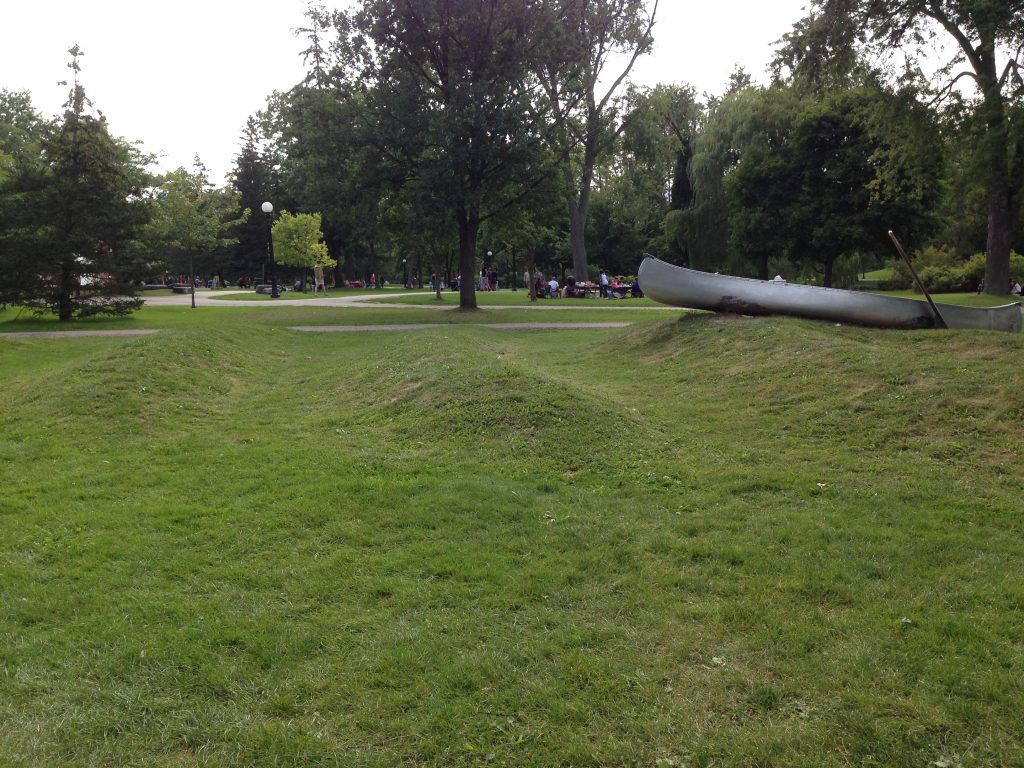 Photo of a canoe on grass.